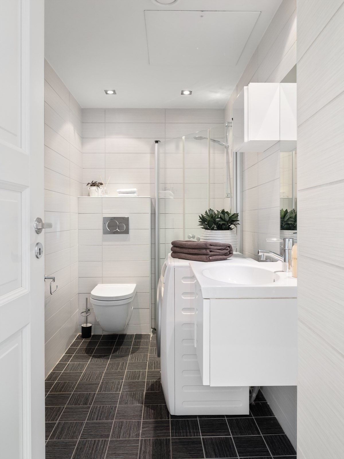 Delikat flislagt bad med gulvvarme og downlights Galleribilde