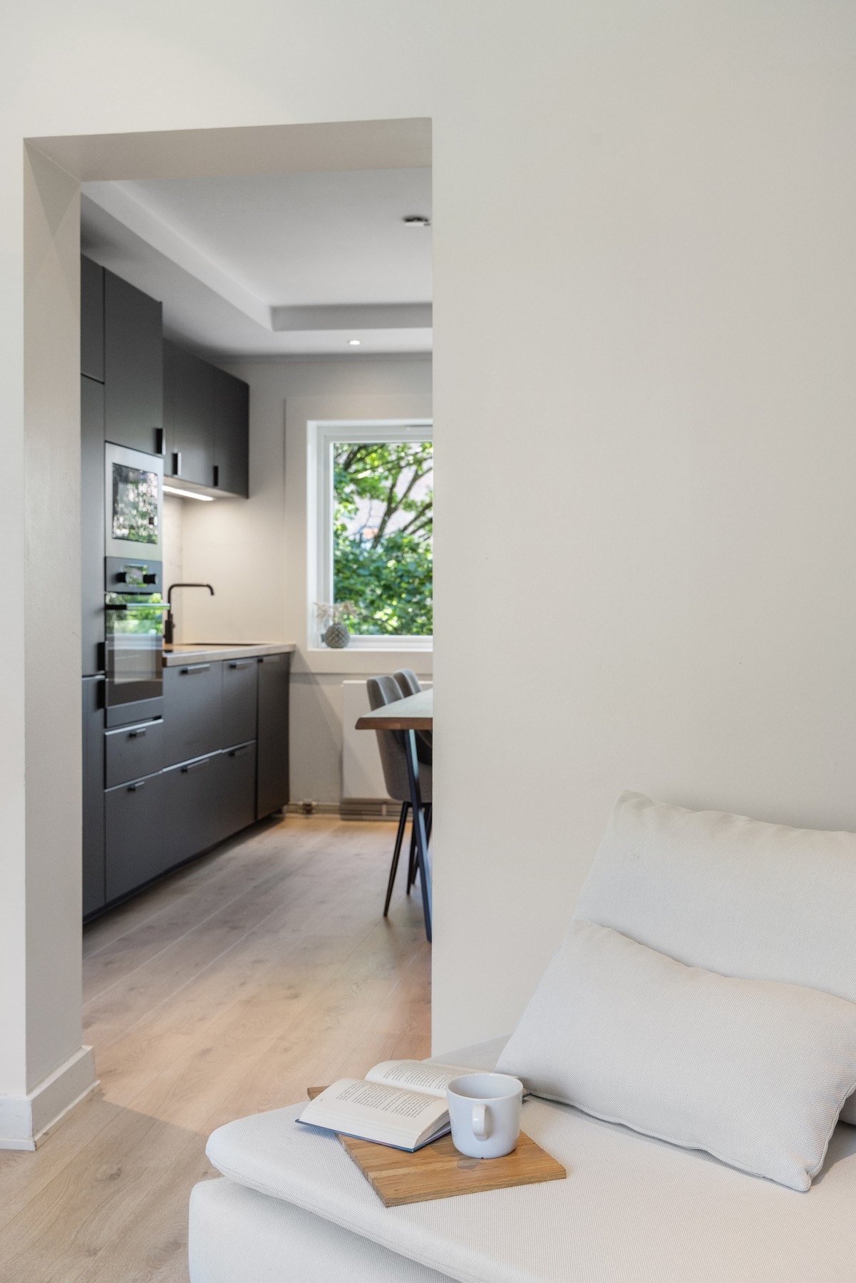 Stuen er adskilt fra kjøkken og spiseplass gjennom en åpen løsning i veggen, noe som gir et fint samspill mellom rommene samtidig som stuen beholder sin egen sone. Galleribilde