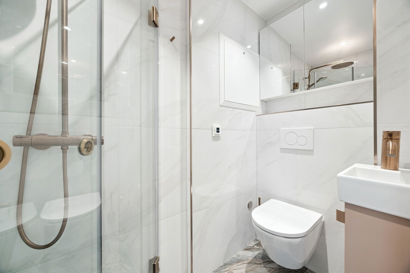 Bad 2 med dusj, toalett og speilskap. Sevant med underskap og downlights i tak. Tilgnang fra entré. Galleribilde