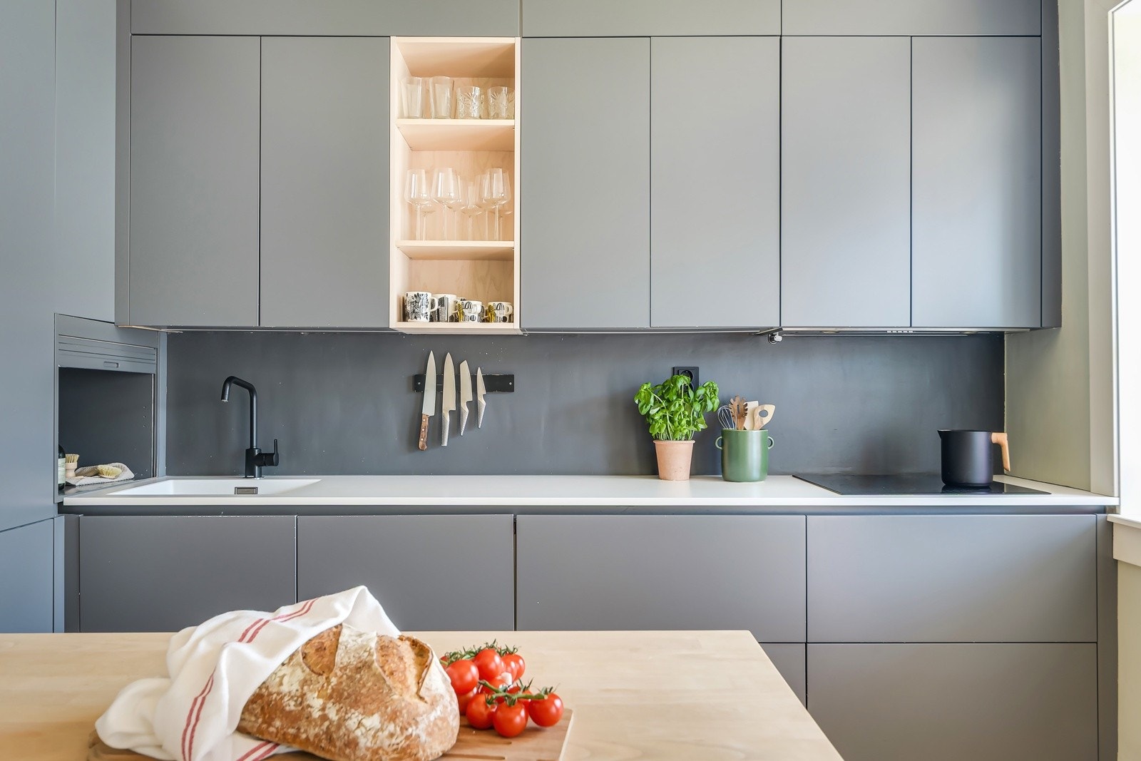 Innredningen er fra anerkjente Svane og ble montert i 2016/17. Kjøkkenet fremstår moderne og elegant med glatte grå fronter, slitesterk laminatbenkeplate og nedfelt oppvaskkum (nytt armatur ble montert i 2023). Galleribilde