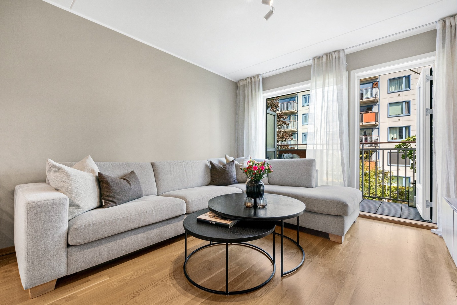 Stuen åpner opp mot en delikat balkong, som på sømløst vis utvider oppholdsrommets bruksareal og gir en luftig følelse av ute og inne i harmoni. Galleribilde