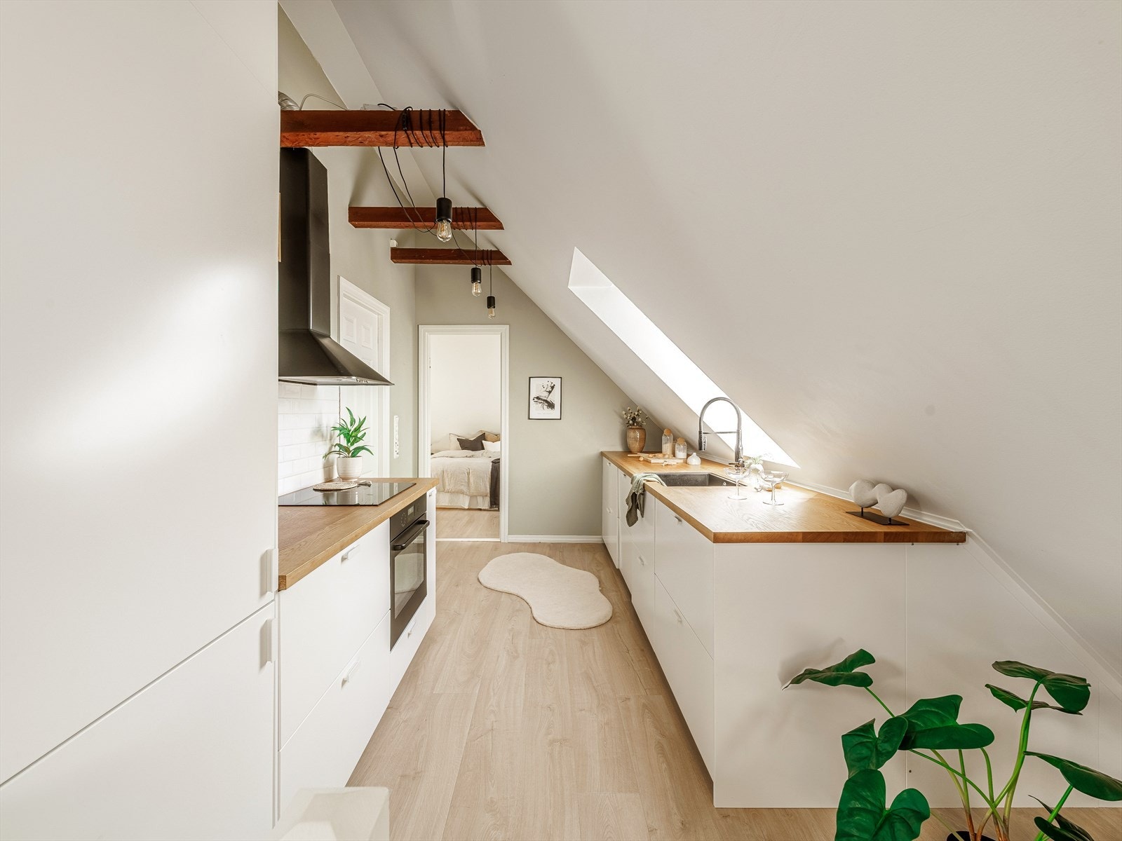 Nytt Ikea kjøkken montert i 2021 i hvit slett utførelse, eik benkeplate og fliser over ene siden. Det er varmekabler i gulvet på kjøkkendel. Galleribilde