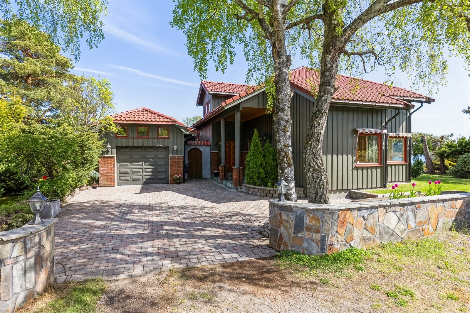 Foran huset er det en stor, steinbelagt gårdsplass og støpte, skiferkledde gjerder. Galleribilde