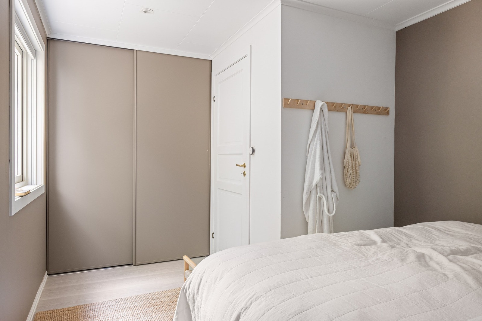 Flott hovedsoverom på 10,9 m² med skyvedørsgarderobe malt i samme farge som veggen. Galleribilde