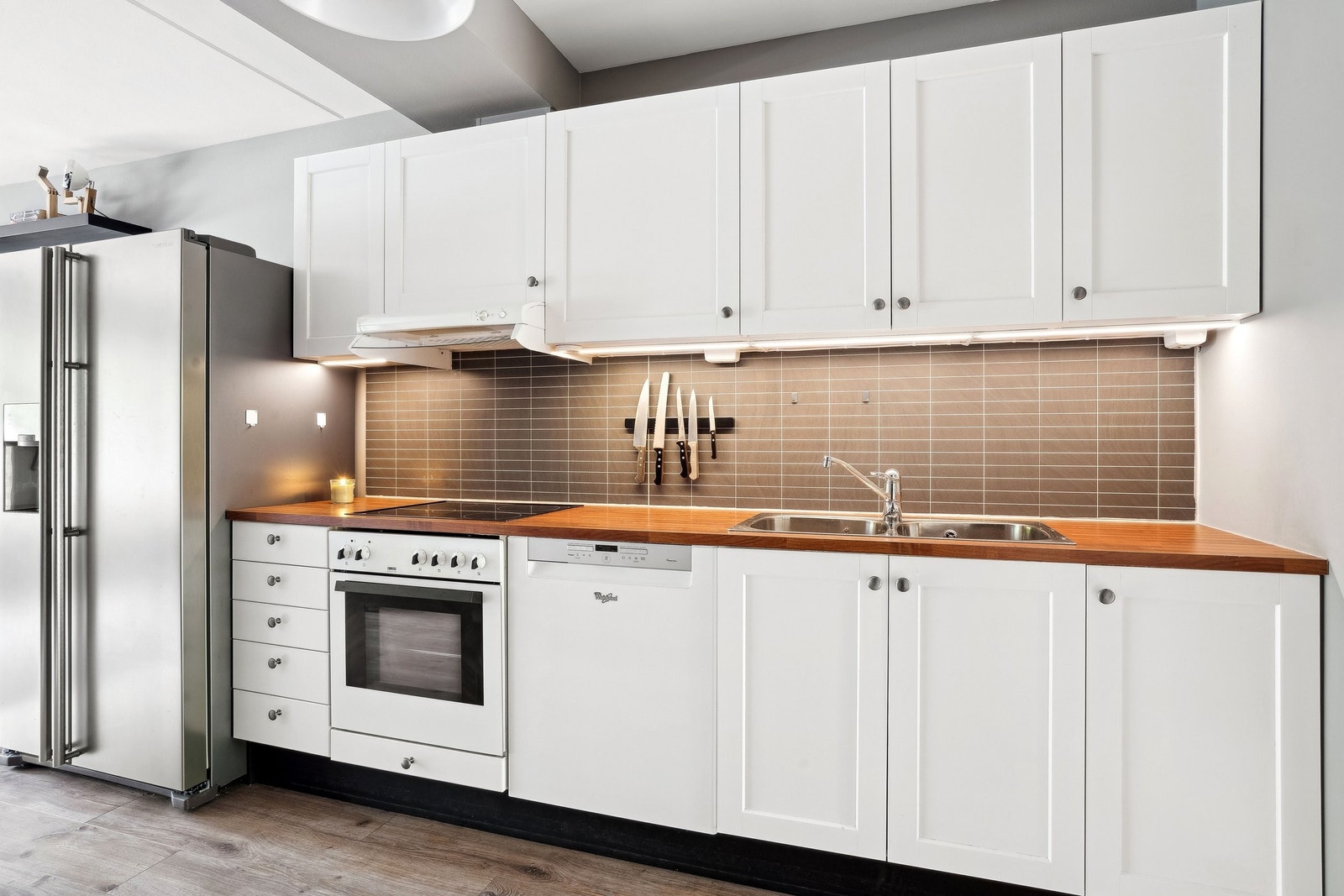 Kjøkken i passelig størrelse med masse hylleplass. Galleribilde