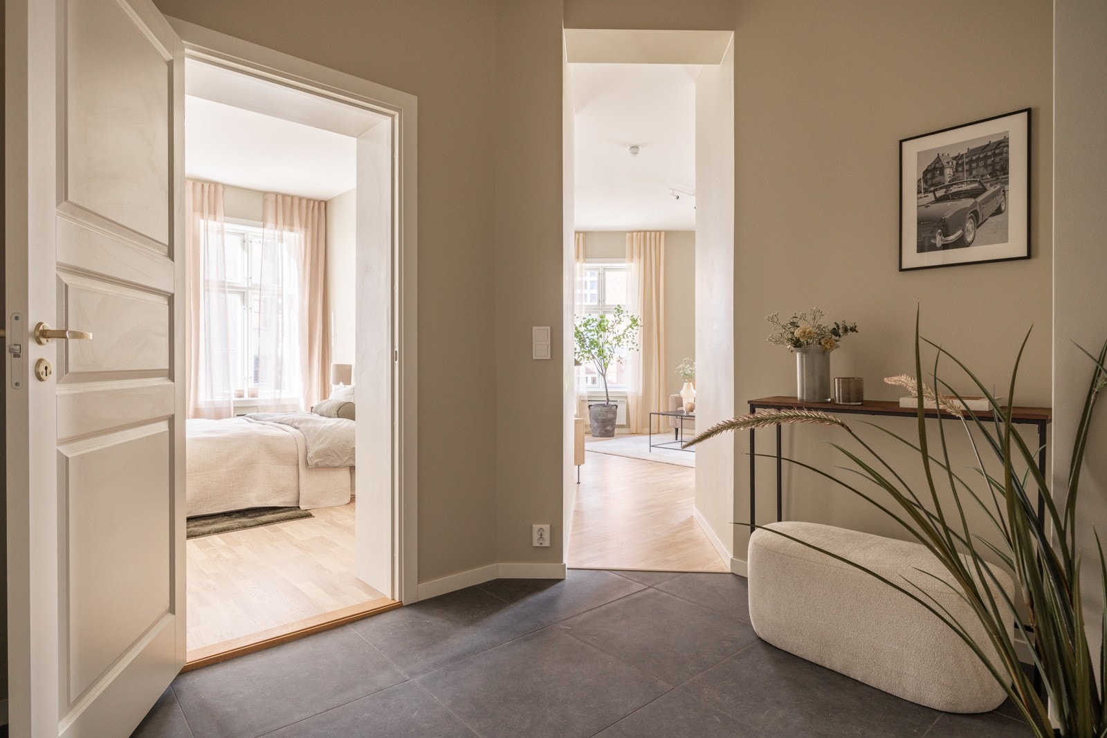 Lys, romslig og innbydende entré med plass til oppbevaringsløsninger som skoskap, kommode, knagger etc. Galleribilde