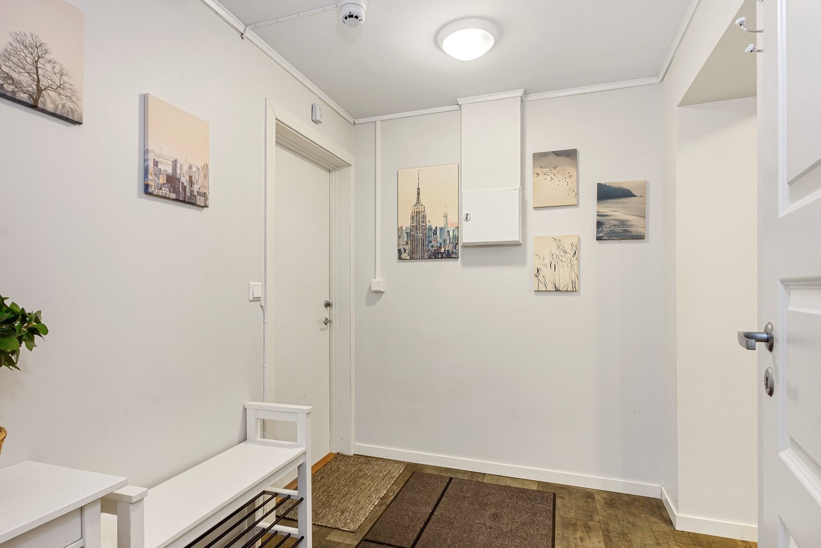 Gangen har plass til oppheng av tøy og til å sette fra seg sko. Mellomgangen har garderobeløsning med speilfronter og ellers har boligen laminatgulv og lyse overflater. Galleribilde