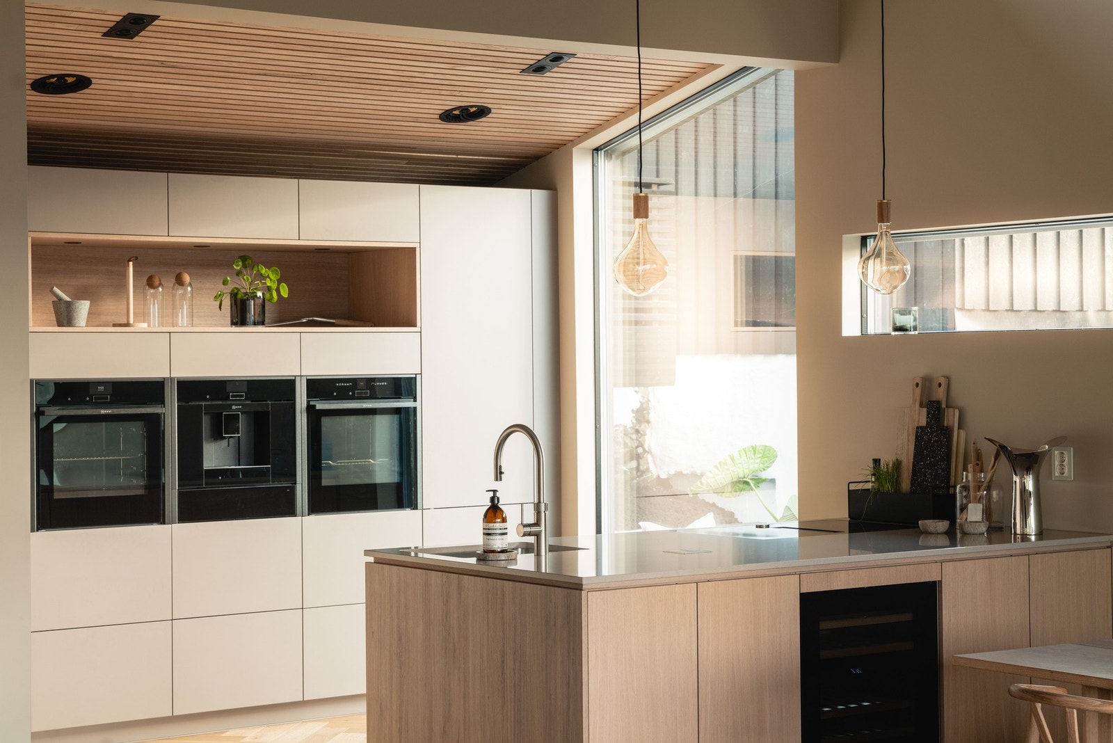 Integrert stekeovn, dampovn, kaffemaskin, varmeskuffe, platetopp med avtrekksvifte, oppvaskmaskin og kjøleskap med frys. Galleribilde