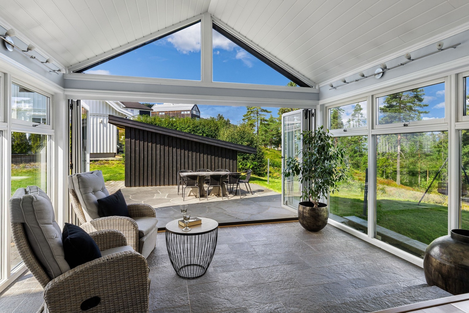 I forlengelse av stuen har boligen en innglasset hagestue med skiferfliser og herlig atmosfære. Galleribilde