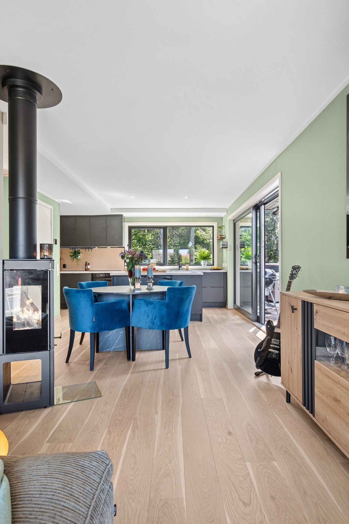 Stor åpen stue/-kjøkken løsning med en deilig vedovn i senter. Galleribilde