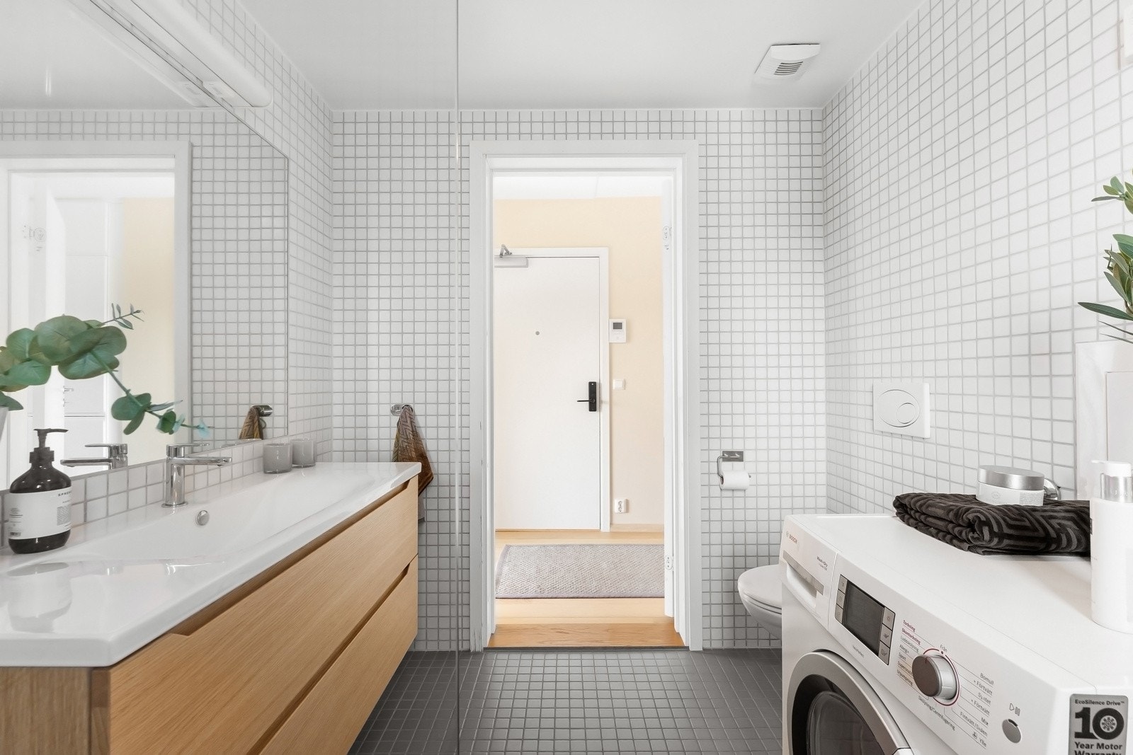 Innredningen består av nedfelt servant, veggmontert toalett, dusjhjørne med glassvegger og opplegg for vaskemaskin. Mekanisk avtrekk og tilluft ved dør. Galleribilde