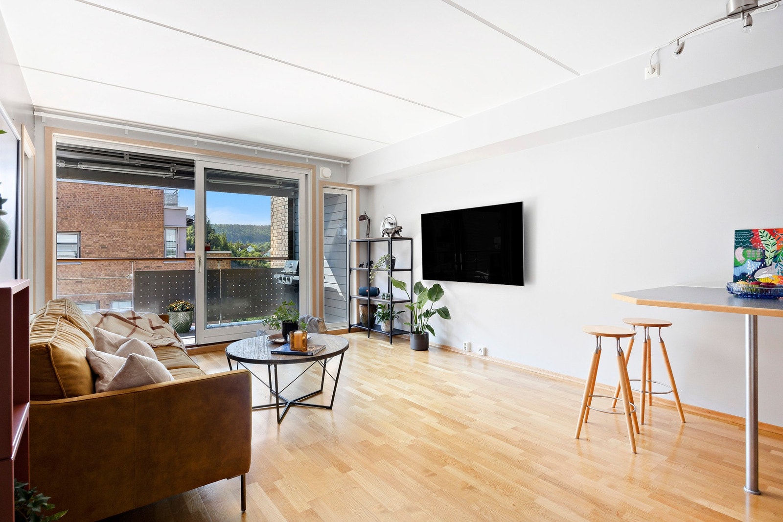 Stuen oppleves lys med stor skyvedør av glass til balkongen Galleribilde