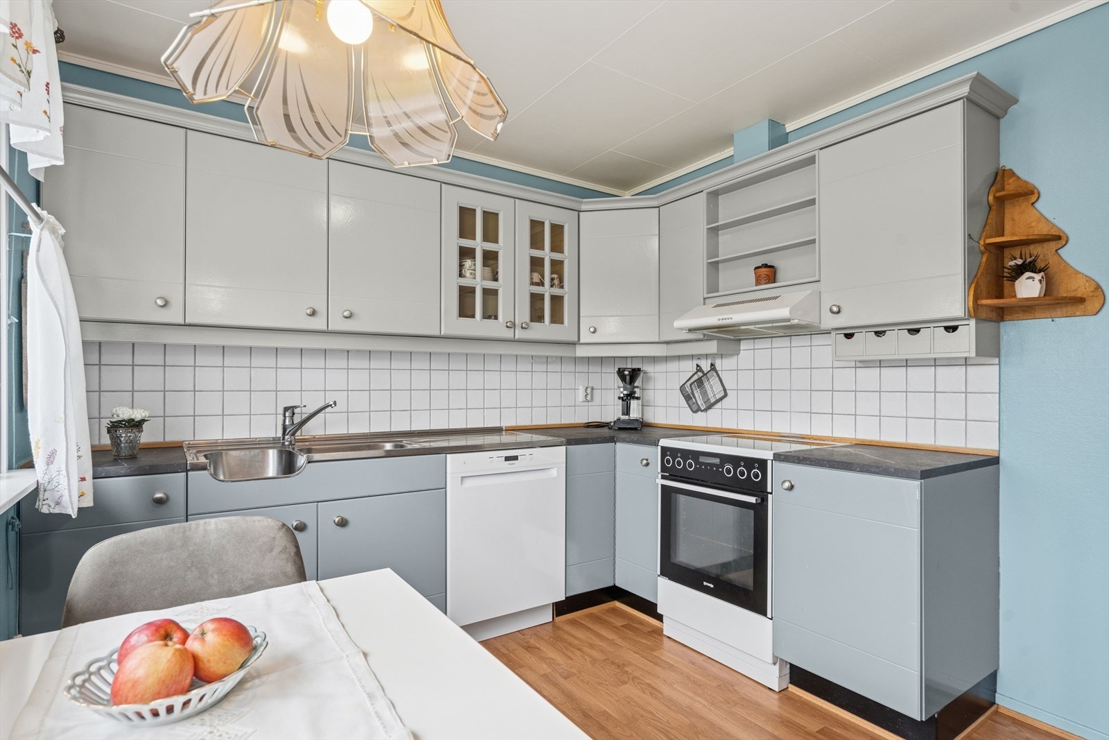 Lyst og funksjonelt kjøkken med innredning bestående av finerte og heltre skrog og fronter. Galleribilde