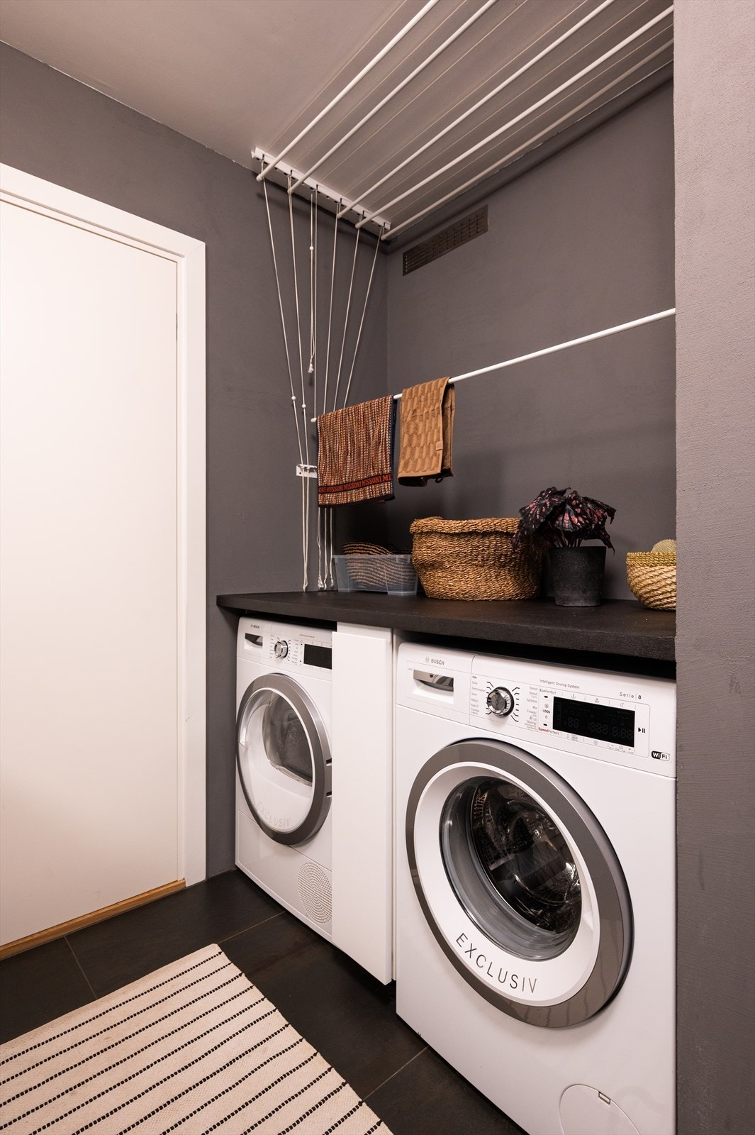 Praktisk opplegg for vaskemaskin og tørketrommel under benkeplate gir gode vaskemuligheter. Galleribilde