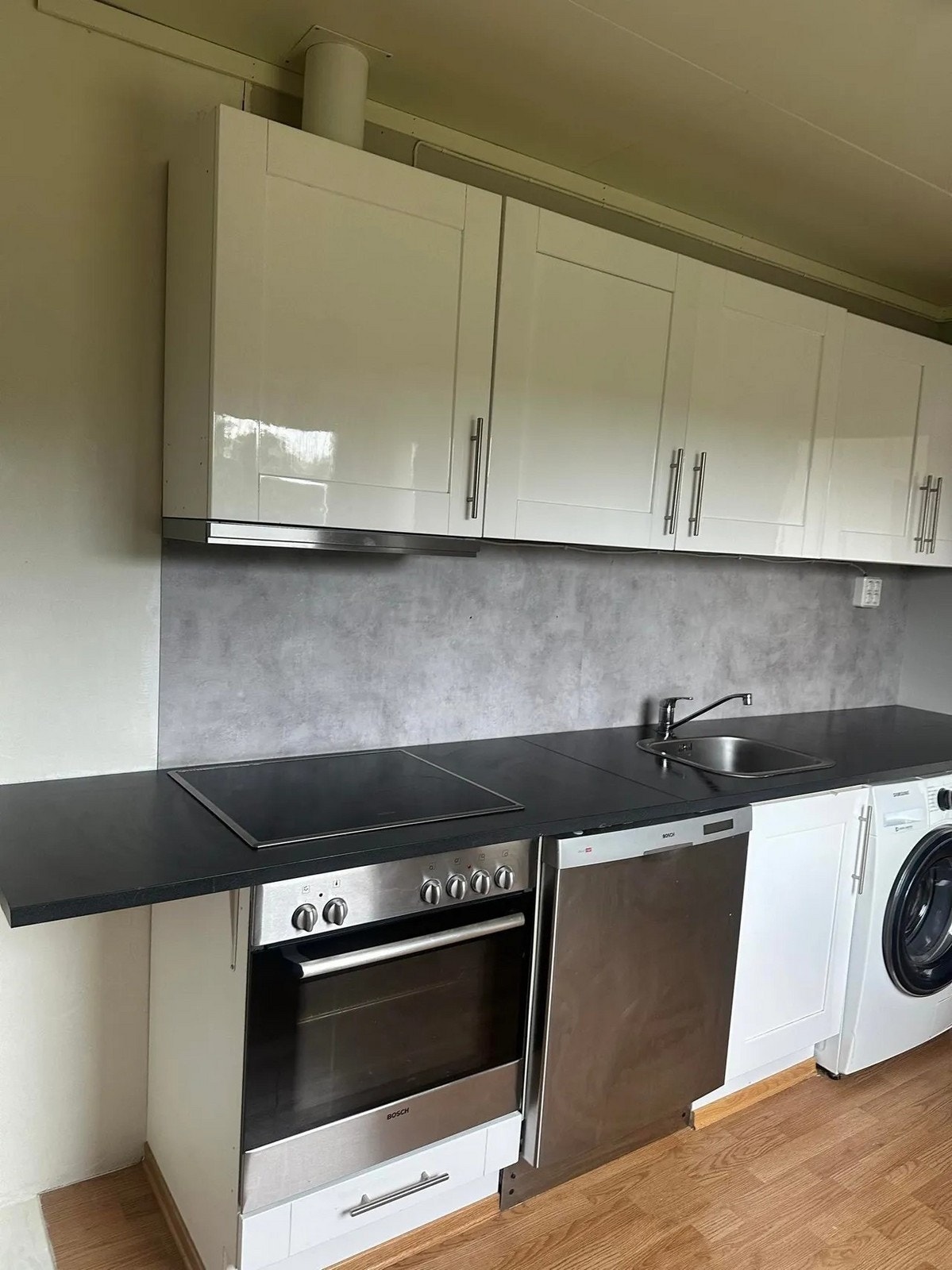 Kjøkkenet er utstyrt med integrert stekeovm og platetopp. Frittstående oppvaskmaskin og vaskemaskin. Galleribilde