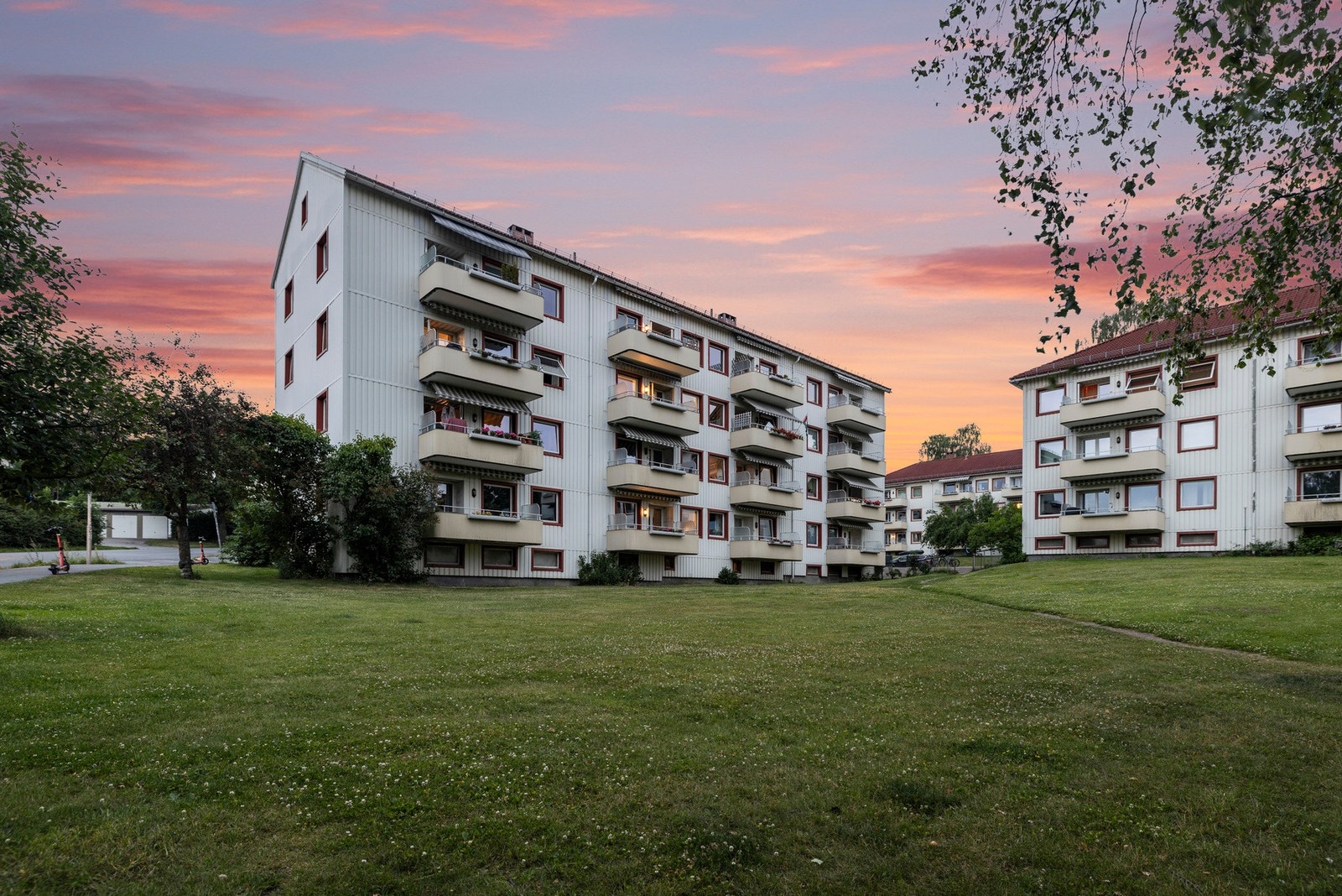 Fellestomten er pent opparbeidet med plenarealer, prydbusker, trær og asfalterte internveier Galleribilde