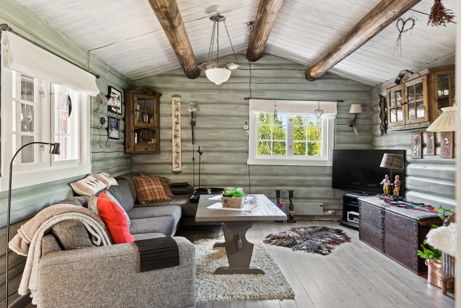 Stuen byr på hyggelig atmosfære med synlige bjelker og solide tømmervegger. Galleribilde