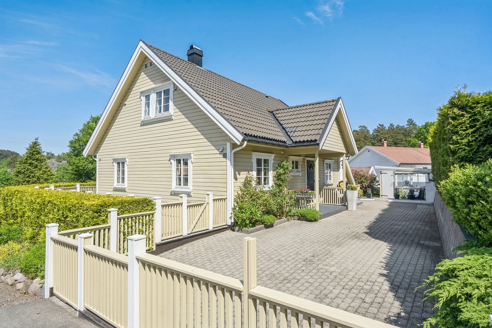 Enebolig med sjarmerende stil. Tomten er gjort lettstelt med stor uteplass med belegningsstein ved inngangen Galleribilde