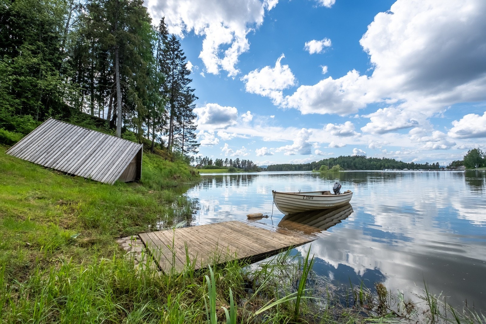 Ved vannkanten ligger det er båthus med vinsj for å trekke båt opp fra vannet og inn i båthuset. Galleribilde