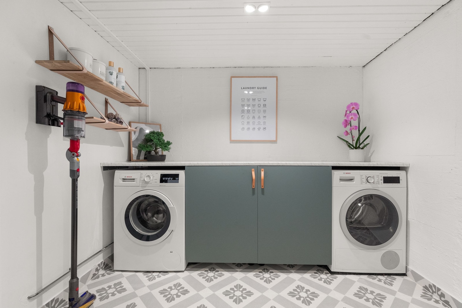 Romslig og svært praktisk vaskerom med opplegg for vaskemaskin og tørketrommel. Rommet ble pusset opp i 2022 med varmekabler, flislagt gulv, innredning og nye downlights spotter (Xpert Installasjon). Galleribilde
