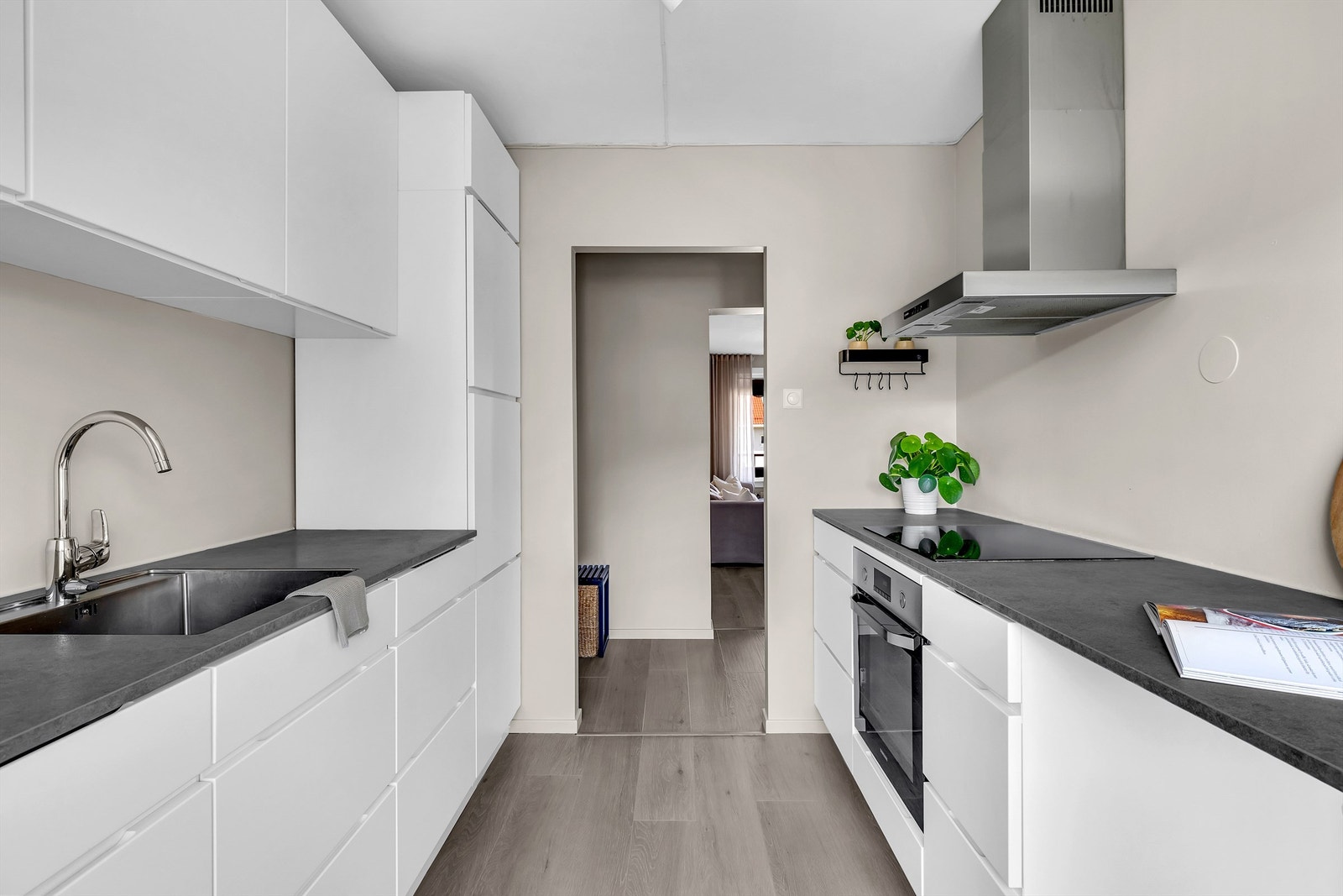 Lysgrå benkeplate med nedfelt oppvaskkum - en praktisk løsning som gjør rengjøring enklere og gir et stilrent utrykk. Galleribilde