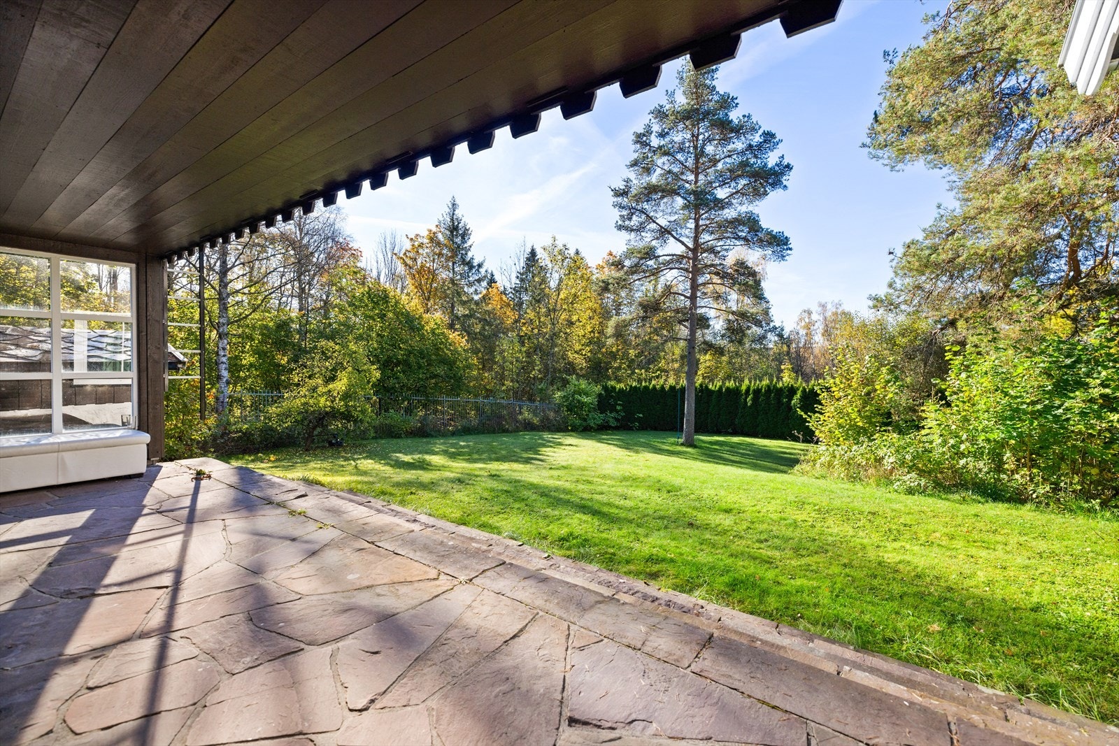 Sydvestvendt skiferbelagt terrasse mot den romslige og opparbeidede hagen Galleribilde