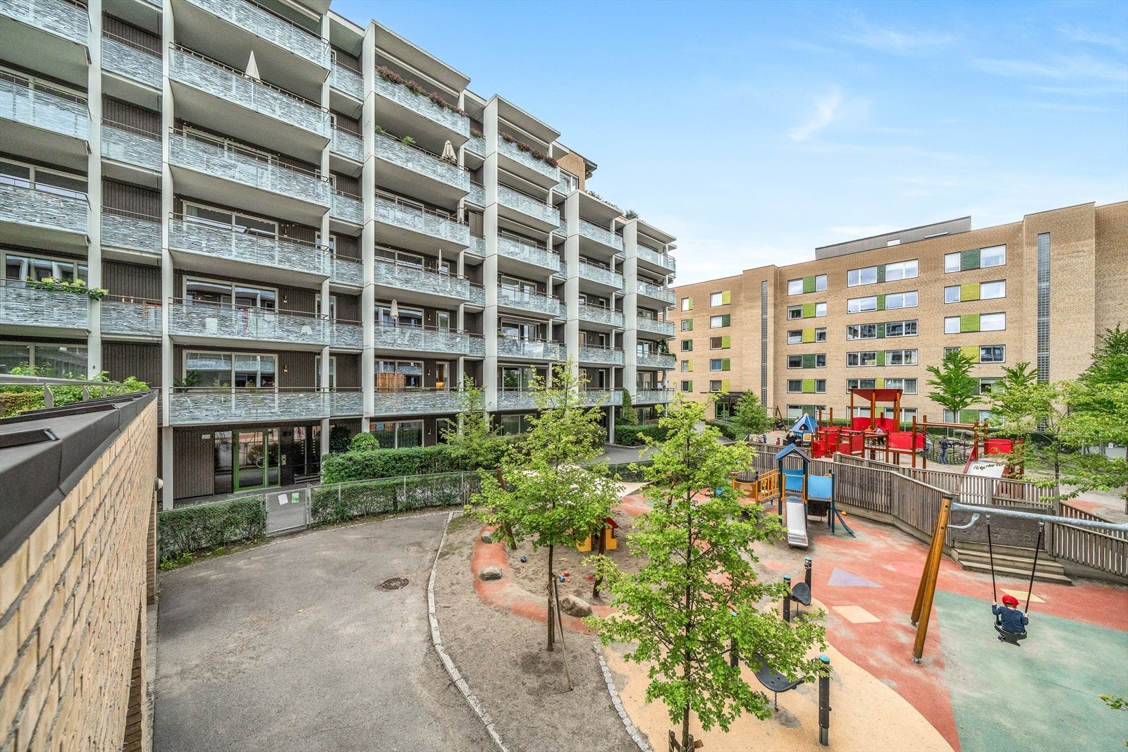 Uteområdene består av sittegrupper, lekeapparater, grøntarealer og en barnehage. Galleribilde