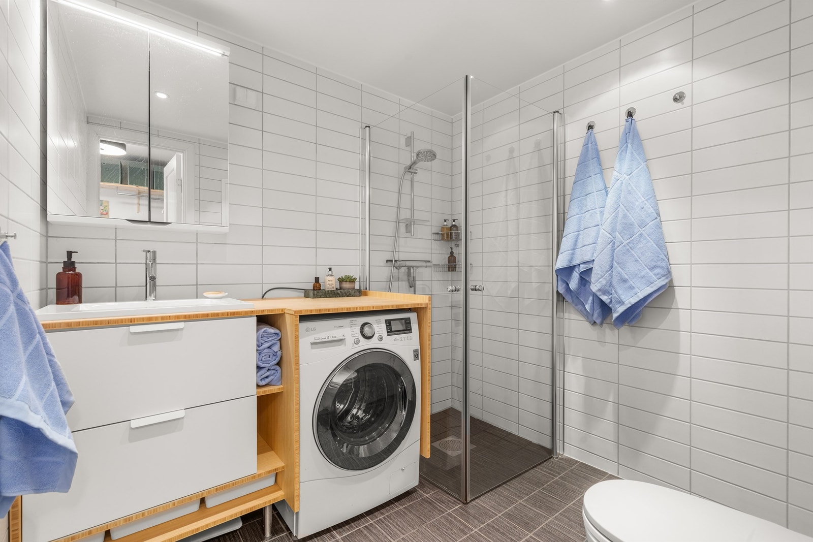 Gjestebadet er i likhet med hovedbadet pent flislagt med gulvvarme. Innredningen består av vegghengt servantinnredning med nedfelt servant og speil over servanten. Galleribilde