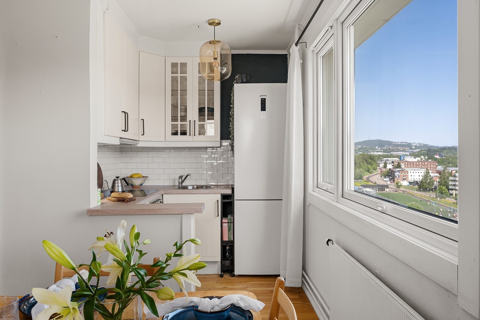 Boligen har en lys og åpen stue- og kjøkkenløsning med profilerte fronter og noen vitrine fronter. Galleribilde