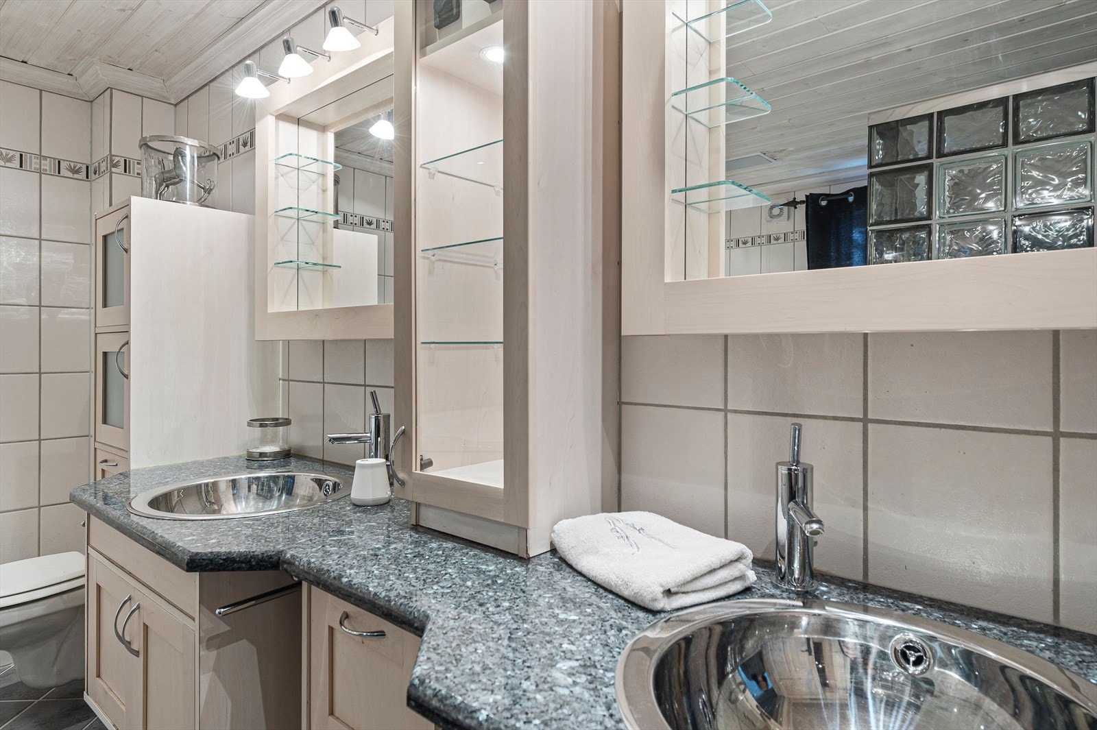 Baderomsinnredningen har to vasker med speil over, samt godt med oppbevaringsplass. Galleribilde