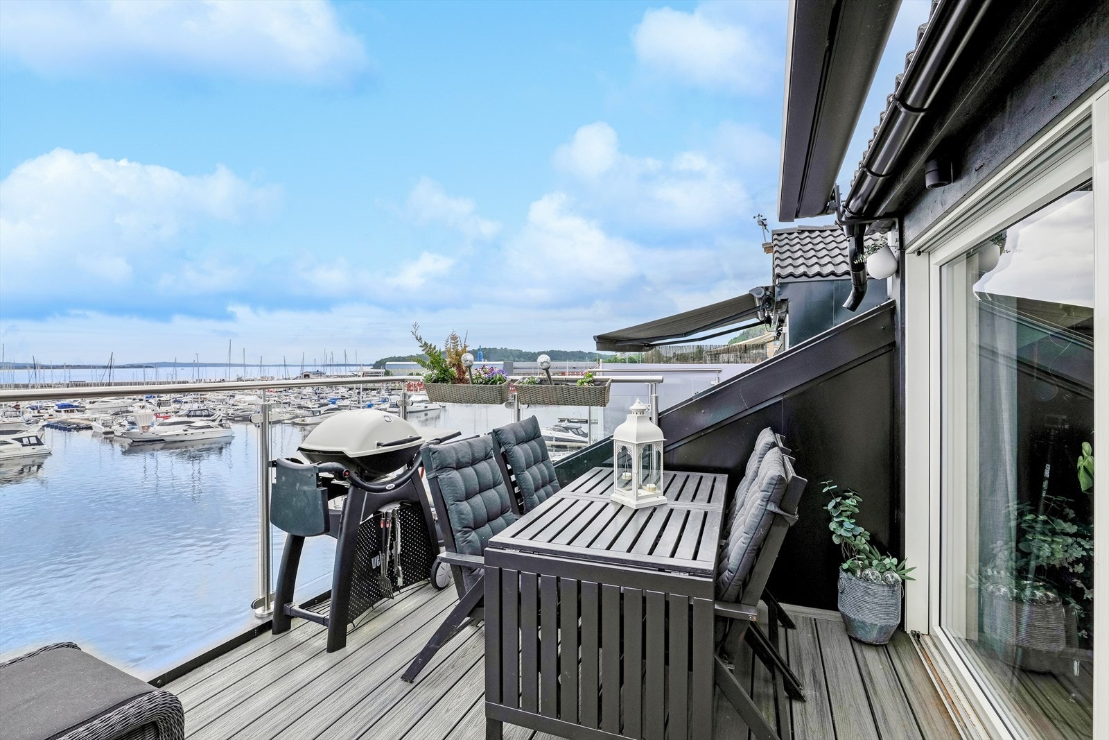 Fra stuen er det videre utgang til en romslig balkong med flott utsikt over fjorden og bryggen i Holmestrand. Balkongen byr på flotte detaljer som glassrekkverk, gelender i syrefast stål og montert praktisk markise. Galleribilde