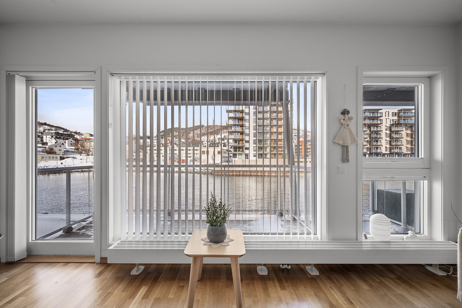 Det er store vindusflater som gir verdifullt dagslys inn, og adkomst fra stua til én av boligens to balkonger Galleribilde