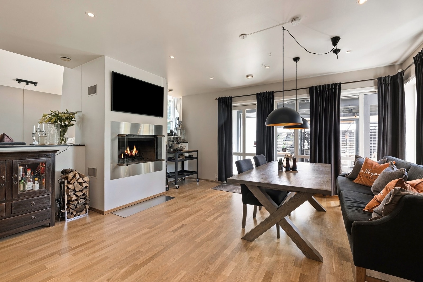 Den gjennomgående peisen skaper en hyggelig atmosfære ved spisebordet. Galleribilde