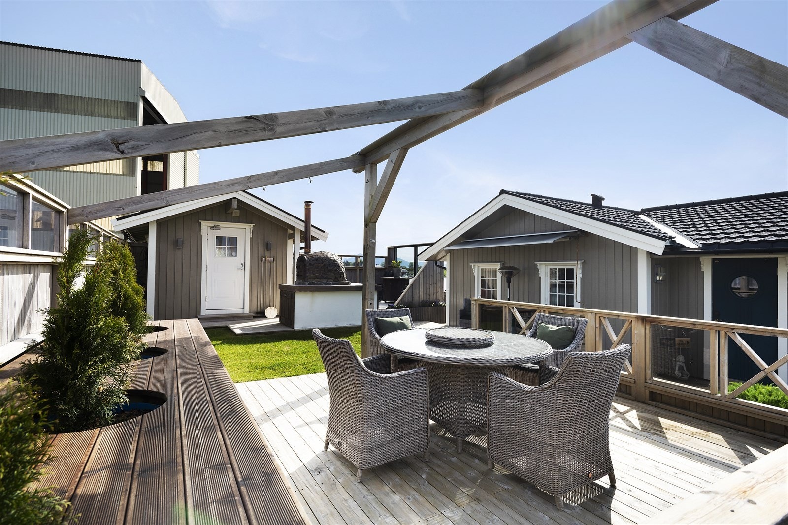 Stelte uteområder med markplattinger som er opparbeidet med blomsterbed og sitteplasser. Galleribilde