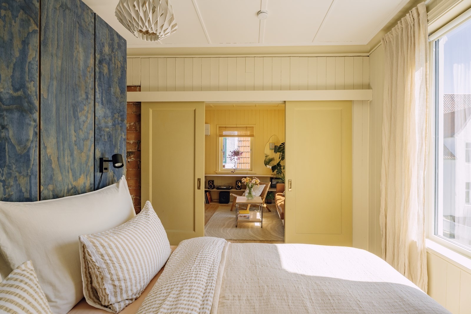 Skyvedørene skaper en sømløs overgang mellom stuen og soverommet, samtidig som de ivaretar rommets åpenhet og gir mulighet for privatliv. Galleribilde