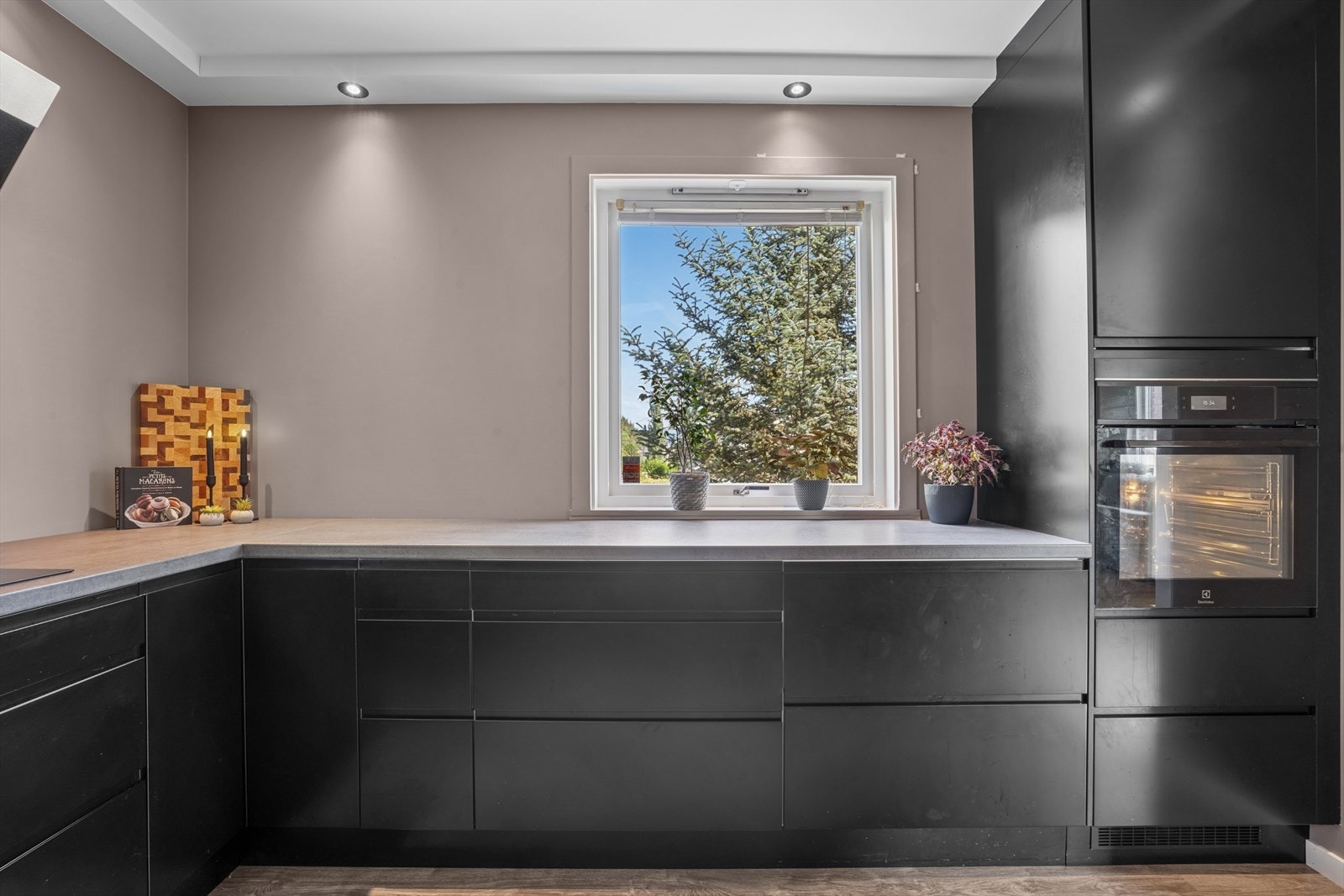 Det er rikelig med skuffe, skap- og benkeplass på kjøkkenet som er U- formet. Komfyren er i god arbeidshøyde. Galleribilde