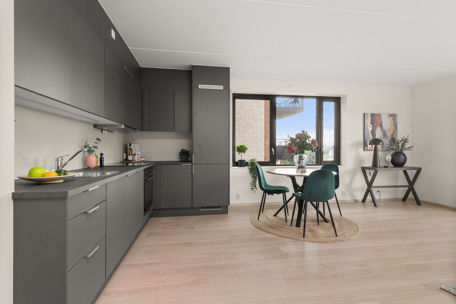 God plass til spisegruppe eller kjøkkenøy som danner et naturlig skille mellom kjøkken- og stuedel. Bilde lånt fra stylet og tilsvarende leilighet etasjen over. Galleribilde