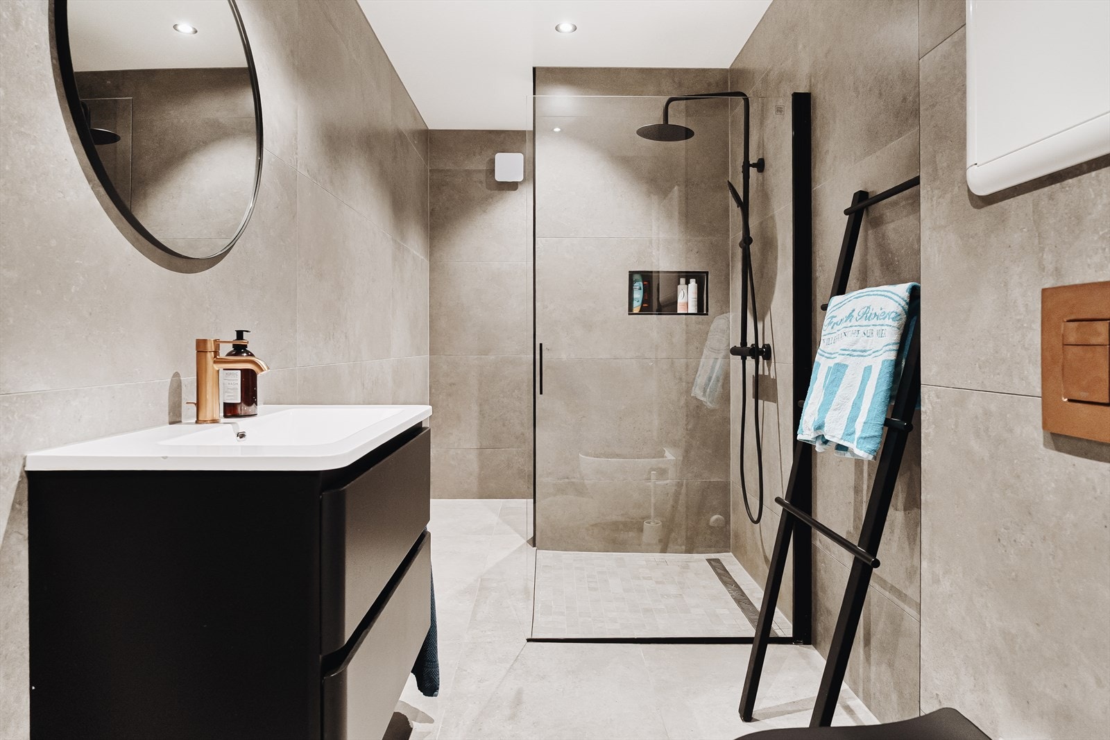 Helfliset bad på 7,7 kvm med dusjløsning med glassvegger, vegghengt toalett, servant med innredning og opplegg for vaskemaskin. Galleribilde