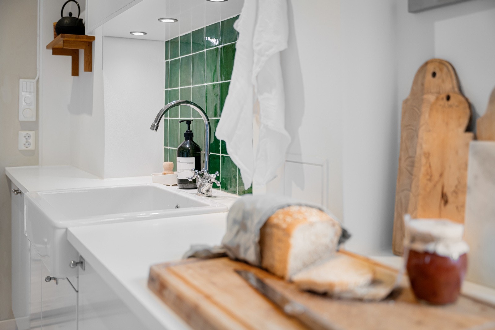 Lyse, glatte fronter, benkeplate av kompaktlaminat og helstøpt keramisk kum. Galleribilde