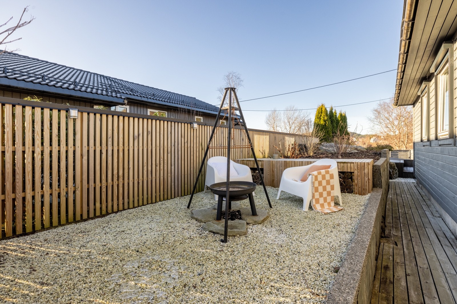 Herlig uteplass på siden av huset, med sittegruppe og bålpanne. Galleribilde