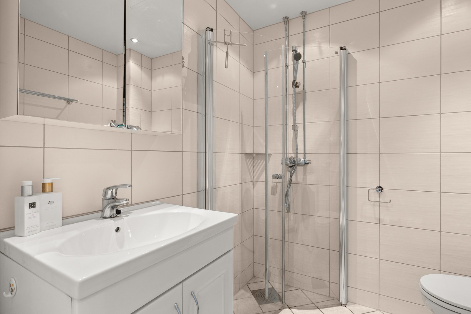 Varmekabler som styres med digital termostat montert på vegg ved dør. Galleribilde