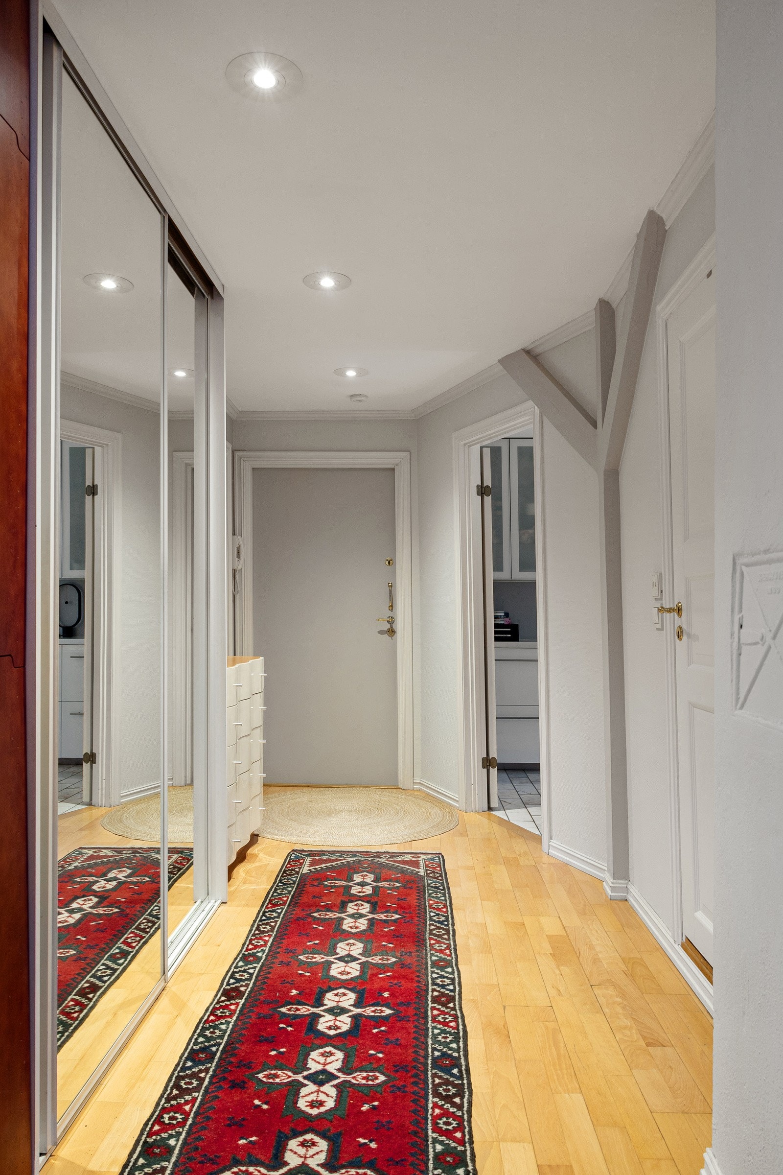 Entréen er romslig og det er en stor skyvedørsgarderobe med speilfronter for oppbevaring av yttertøy og sko. Galleribilde