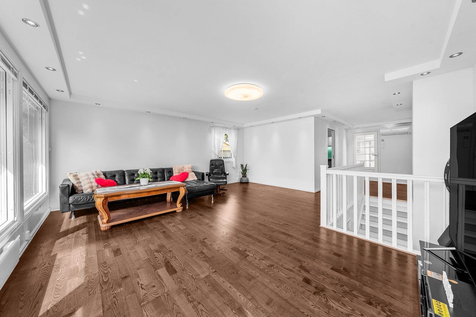 Stort oppholdsrom med parkettgulv, ideelt for både avslapning og gjestebesøk. Galleribilde