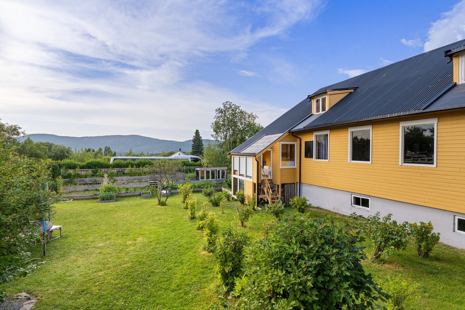 Tomten er særdeles romslig og man har her titalls bær- og buskevekster i tillegg til drivhus og grønnsaksbedd, her er man selvberget på flere typer grønnsaker gjennom året Galleribilde