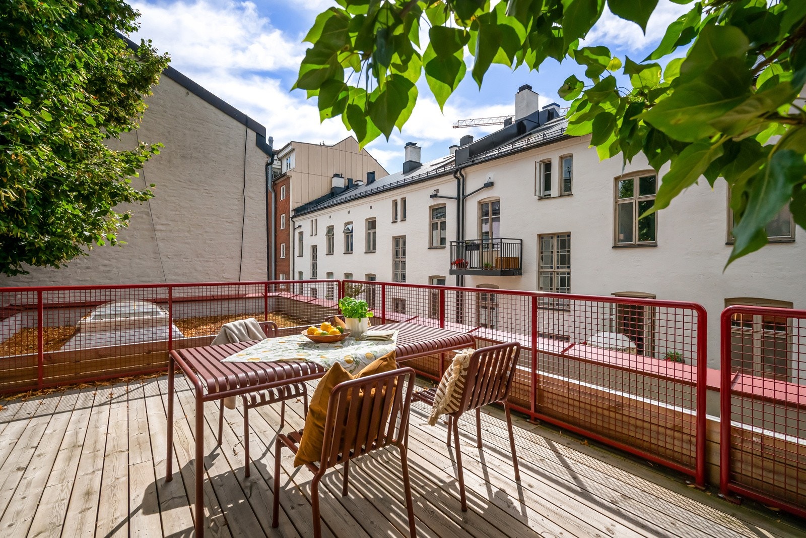 Felles takterrasse med gode solforhold og utsikt mot grønne trær. Galleribilde