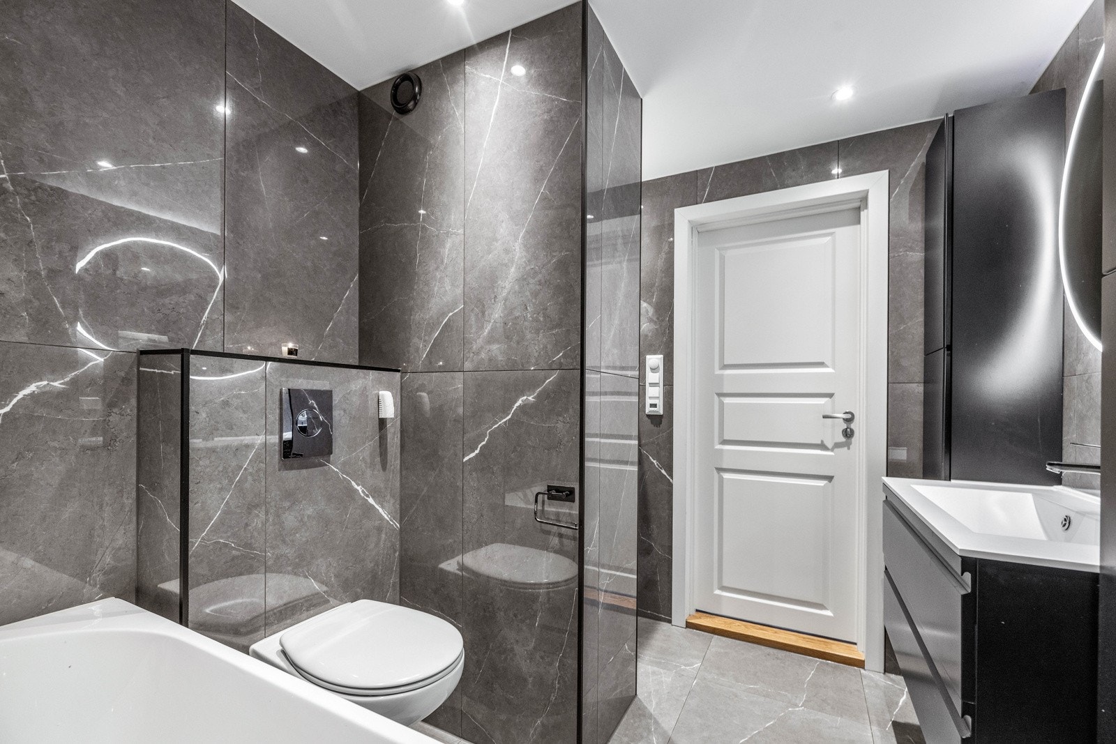 Særdeles gjennomført med lekre fliser, behagelig gulvvarme og mørke detaljer. Galleribilde