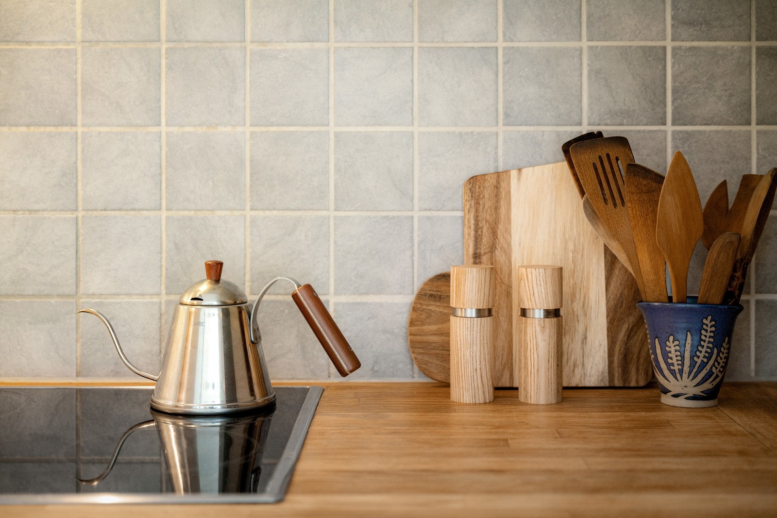 Praktisk med fliser i benkeryggen og belysning under overskapene. Galleribilde