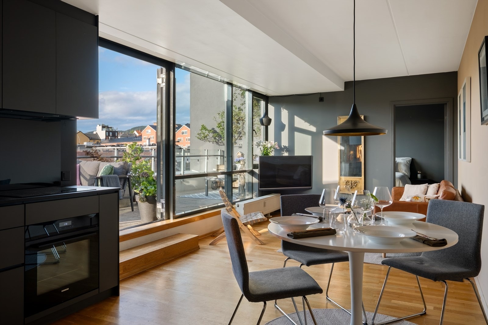 Lys og trivelig stue med store vindusflater som sikrer en unik romatmosfære. Direkte adkomst til privat takterrasse på ca 49 kvm. Galleribilde