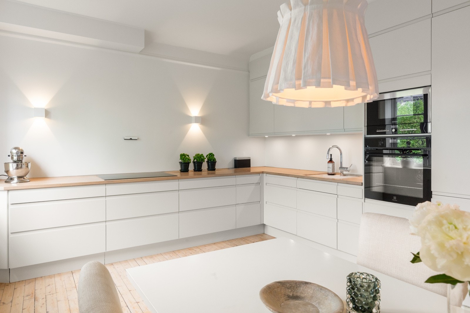 Innredningen har et moderne uttrykk med glatte fronter og heltre benkeplate Galleribilde
