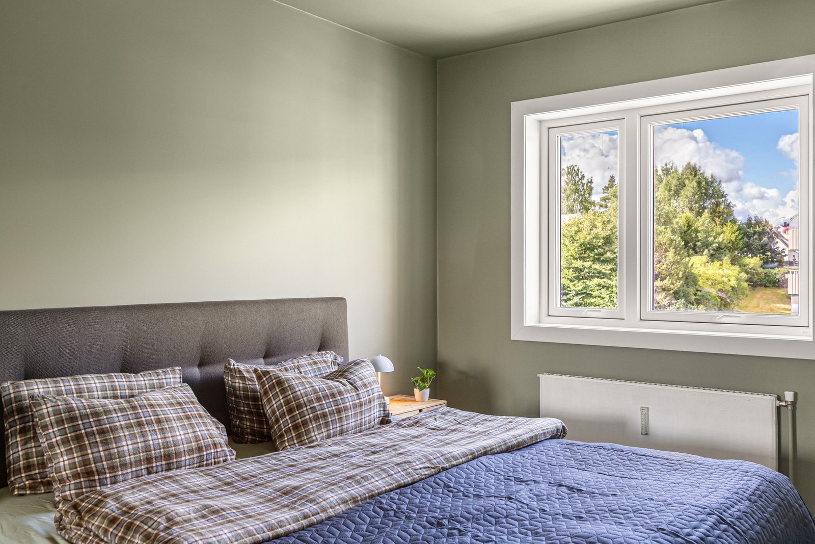 Hovedsoverommet har fin plass til en dobbeltseng med nattbord på begge sider og garderobeskap. Galleribilde